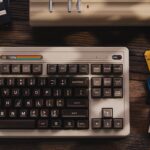 A retro style mechanical keyboard sitting on a desk