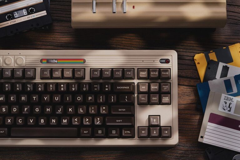 A retro style mechanical keyboard sitting on a desk